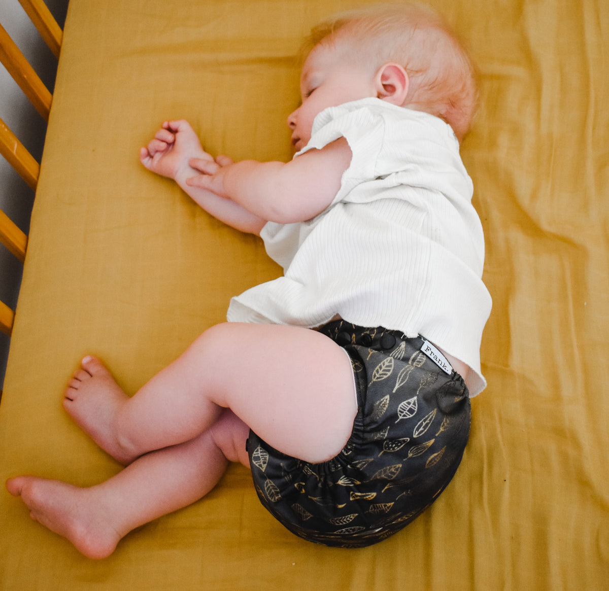 Our nappies also make perfect night nappies for your cloth baby. Photo shows a sleeping baby wearing a leaves cloth nappy